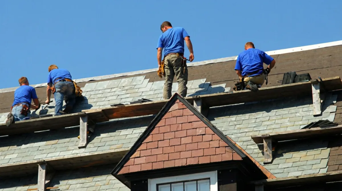 Roof replacement in progress with a team of professional contractors installing new shingles on a residential home in Jacksonville, FL